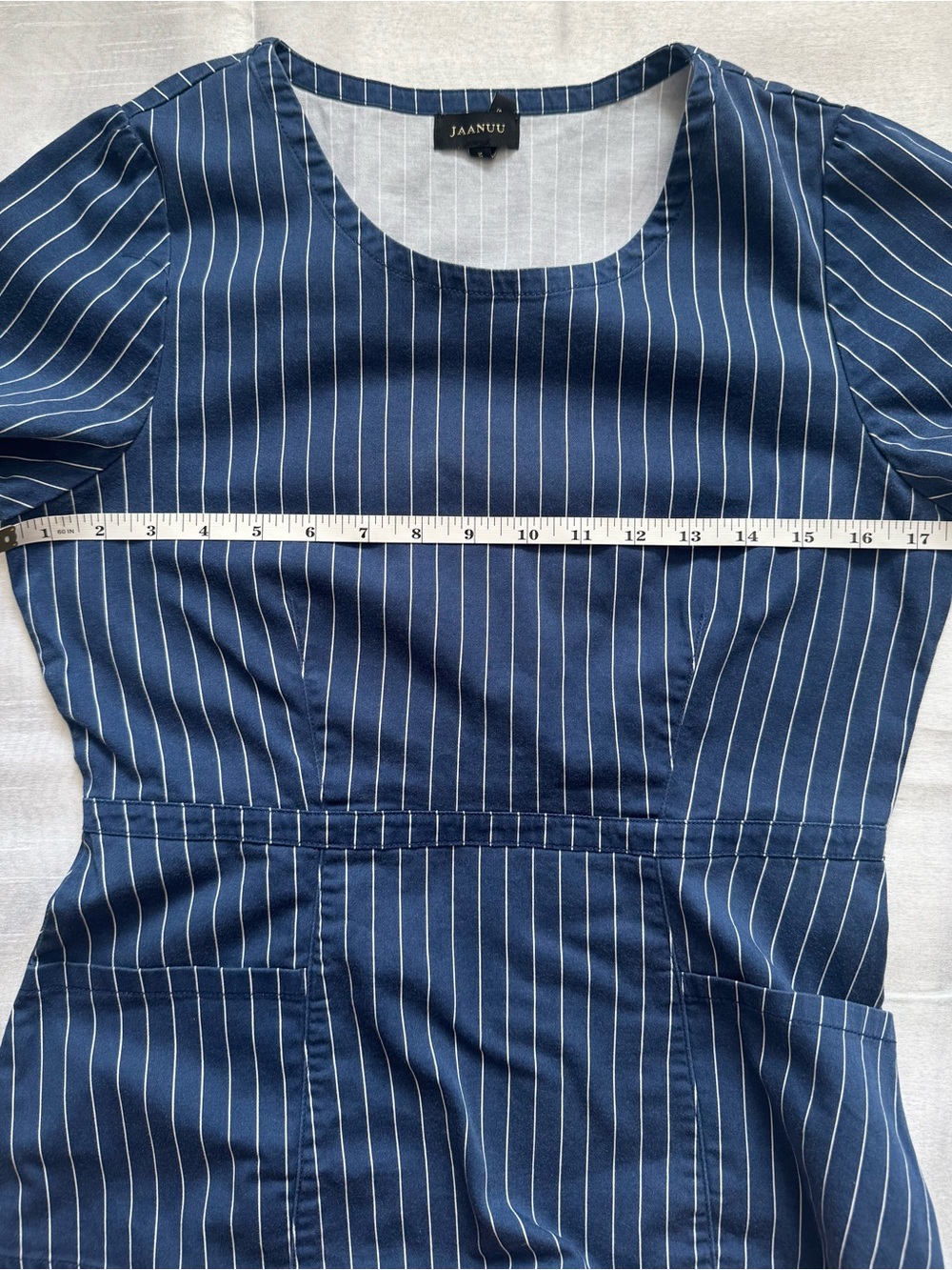 JAANUU Calix Peplum Side Zip Scrub Top Medium Navy Blue Pinstripe EUC